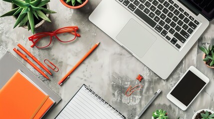 Wall Mural - A flat lay of a workspace with a laptop, notebook, glasses, a pen, a mouse, and a plant.