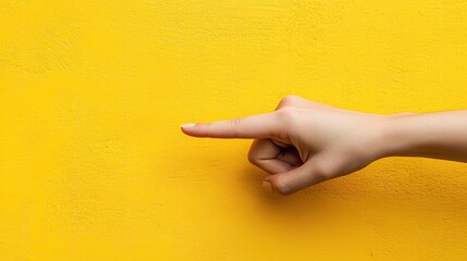 A hand's forefinger pointing left on a bold yellow background, suitable for visual cues or highlighting specific information