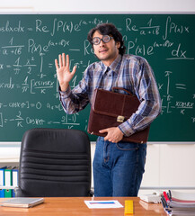 Wall Mural - Funny male math teacher in the classroom