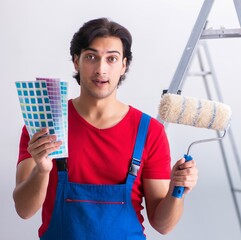 Wall Mural - Young handsome contractor working indoors