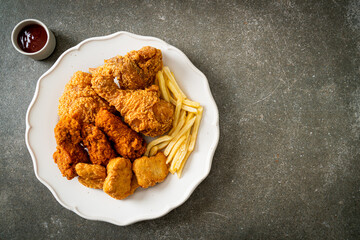 Sticker - fried chicken with french fries and nuggets on plate