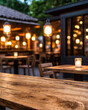 © Emongrapic - photo wooden table and blurred background of outdoor restaurant with bokeh light. High quality photo