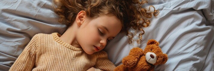 Canvas Print - Young girl with a plush toy peacefully asleep on the bed seen from overhead