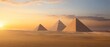 © narak0rn - Three pyramids stand in the desert at sunset, shrouded in mist.