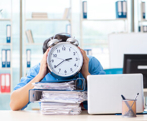 Wall Mural - Handsome businessman unhappy with excessive work in the office