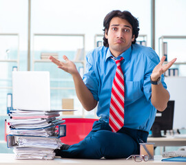 Wall Mural - Handsome businessman unhappy with excessive work in the office