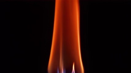 Wall Mural - a close up view of a vibrant flame, showcasing its dynamic motion, heat, and glow against a dark bac