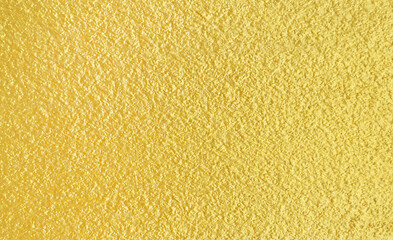 Rough gold-painted walls texture abstract background