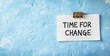 © Unic - A torn piece of paper clipped on a blue background with the words “TIME FOR CHANGE,” symbolizing transformation and new beginnings.