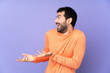 © luismolinero - Caucasian handsome man over isolated purple background with surprise facial expression
