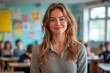 © STOCK IMAGES STALL - Engaging and inspirational female teacher smiling in classroom with students working at desks, copy space for text