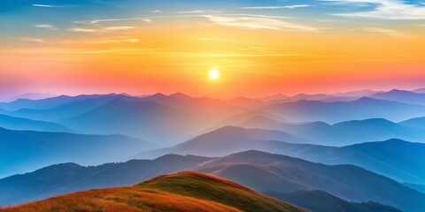 Wall Mural - The sun is setting over a mountain range, casting a warm glow over the landscape. The sky is a mix of orange and blue hues, creating a serene and peaceful atmosphere