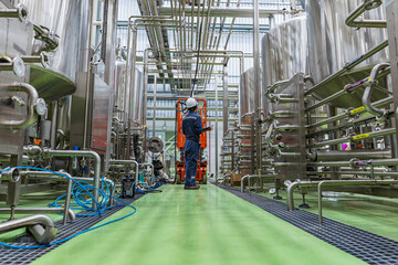 Wall Mural - Male work visual draft inspection process stainless steel tanks and in equipment tank facility for beer drinks cellar at the with vertical stainless