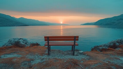 Wall Mural - A bench is sitting on a rocky shore overlooking a lake