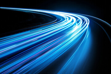 Wall Mural - Long exposure photo of blue light trails on a curved road at night