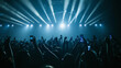 © VK Studio - Enthralled fans capture the electrifying light show and live performances with their phones, creating a sea of glowing screens in a euphoric, high-energy concert environment.