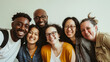 © VK Studio - A group of six friends smiles warmly in a close-knit group photo against a plain background, showcasing friendship, diversity, and genuine happiness.
