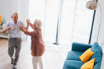 Wall Mural - Celebrating Retirement: Elderly Couple Embrace Love and Happiness at Home, Fun-filled Life of Dancing, Smiling, and Bonding Together, Cherishing Family and Romance in Their Golden Years