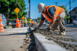 © Татьяна Евдокимова - Construction worker smoothing concrete on a sidewalk project, working diligently on a sunny day