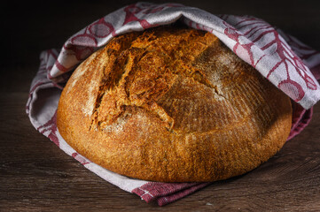 loaf of bread on wooden background, food closeup