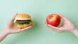 © dobok - Healthy Choices Delicious Burger Fresh Apple Hands Green Background