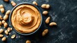© Matcha_09 - Close-up top view of a bowl of peanut butter with peanuts scattered on the table, emphasizing texture and leaving space for additional text