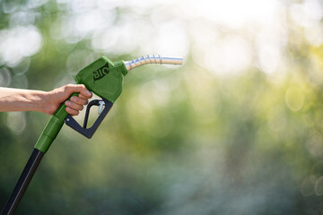 Wall Mural - Hand with green refueling nozzle with the inscription BIO