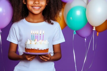 Positive young african girl kid holding birthday cake isolated on purple background.