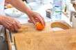 © HelgaQ - Senior Preparing Apricots on Wooden Cutting Board in Modern Kitchen
