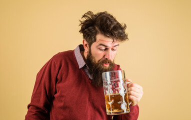 Wall Mural - Leisure and beer time. Drunk bearded man tasting fresh brewed beer. Oktoberfest festival. Brewer with glass of craft beer. Germany traditions. Alcohol. Handsome male drinking draft beer in bar or pub.