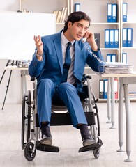 Wall Mural - Male employee in wheelchair working at the office