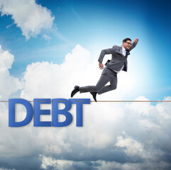 Canvas Print - Debt and loan concept with businessman walking on tight rope