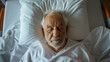 © Nemanja - Top above view of senior old man sleeping in white hospital bed. Patient illness or disease recovery treatment and resting in room, sick elderly person lying, alone, therapy, surgery