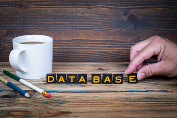 Wall Mural - data base. old letter tiles on a wooden texture office table