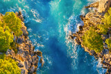 Fototapeta  - Drone view of the sea coast. Rocky shore and sea water. Vacation and travel. Summer seascape. aerial view. Image for cards, background, wallpaper or design.