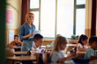© Drazen - Happy teacher and her students during class at elementary school.