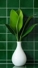 Wall Mural - White vase with green leaves in front of green tiled wall, modern interior decor concept