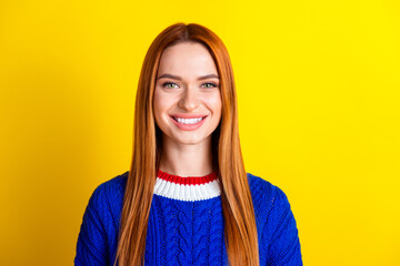 Wall Mural - Photo portrait of attractive young woman cheerful toothy smile dressed stylish blue knitwear clothes isolated on yellow color background