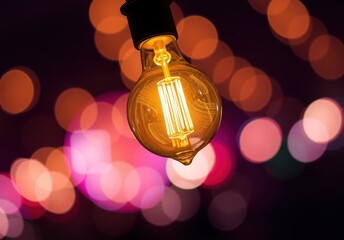 Wall Mural - Illuminated Bulb with Bokeh Background.