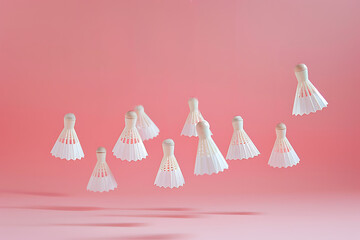 white shuttlecocks on a pink background	
