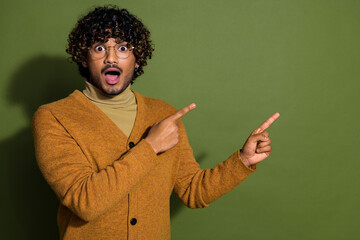 Wall Mural - Photo portrait of pretty young male point shocked empty space wear trendy brown outfit isolated on khaki color background