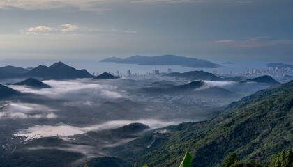 Wall Mural - The sunrise on the high mountains, far away is the famous coastal tourist city of Nha Trang