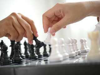 Two business women play a game of chess To be a concept of business competition and problem solving For always good results