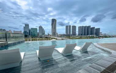 The Opera Residence, Ho Chi Minh City, Vietnam - July 28, 2024: The Opera Residence's infinity pool overlooking Thu Thiem 2 Bridge in Ho Chi Minh City, Vietnam