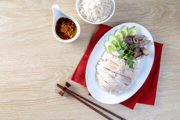 Wall Mural - Steamed rice topped with chicken on the wooden table