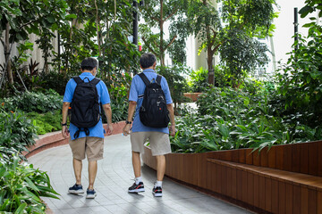 senior asian tourists walking at indoor park