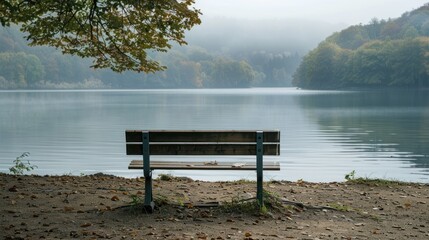 Canvas Print - A single bench overlooking a serene lakeside view