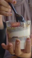 Poster - Healthy Chia Pudding with Granola and Strawberries served in a transparent glass