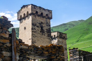 Two towers and stone wall. Mountain landscape. Fortress towers of the village of Ushguli.