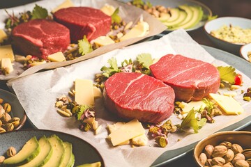 Wall Mural - A plate of meat and cheese with a green leaf on it